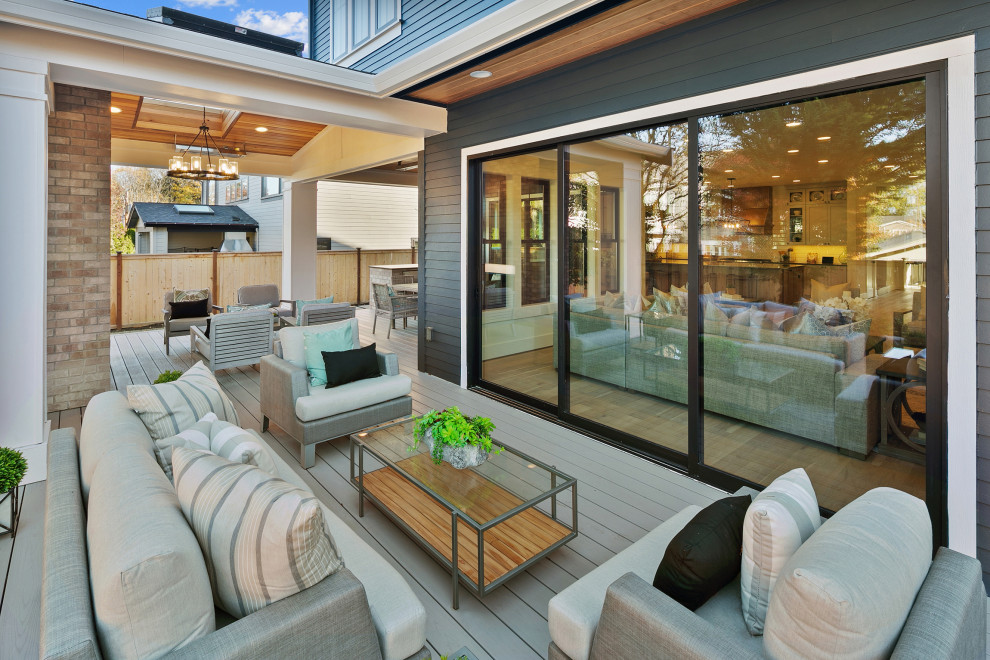 Inspiration for a large country porch remodel in Seattle with decking and a roof extension
