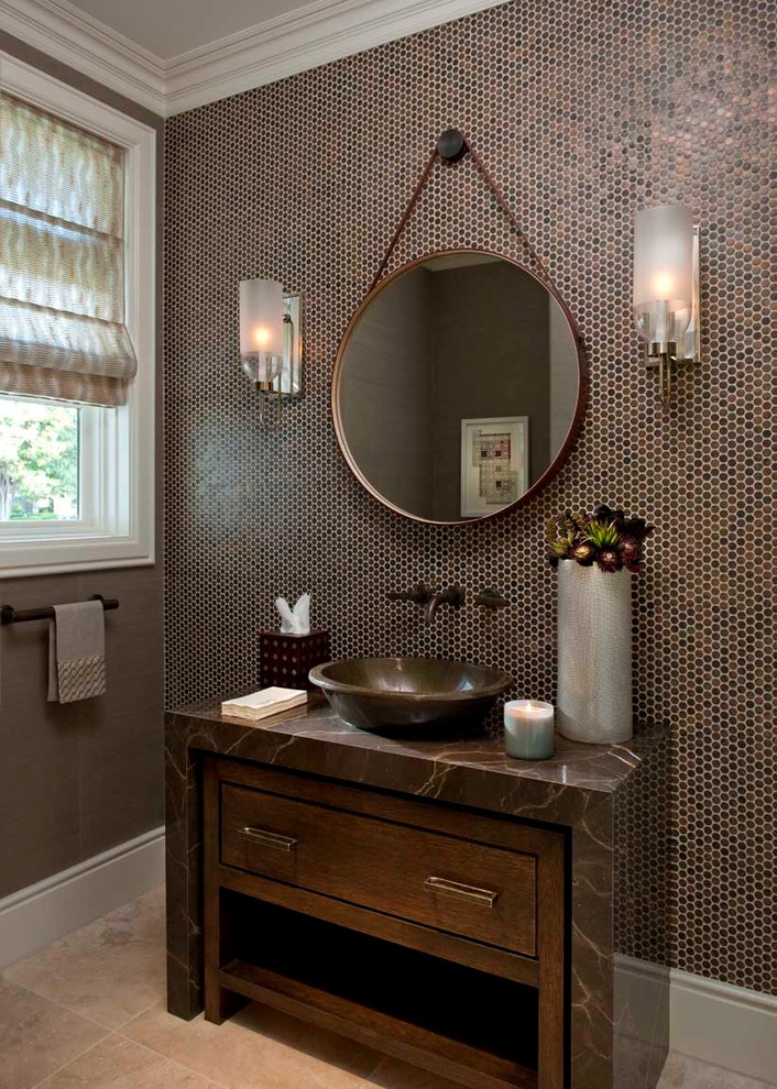 This is an example of a mid-sized contemporary powder room in Dallas with a vessel sink, furniture-like cabinets, brown tile, mosaic tile, granite benchtops, travertine floors, dark wood cabinets and brown benchtops.