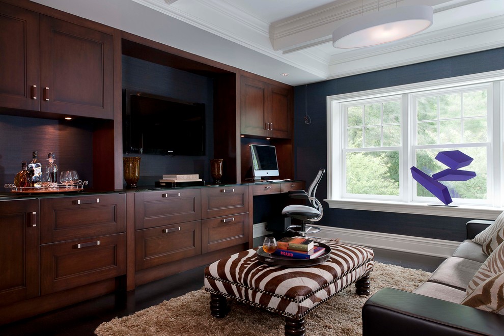 This is an example of a contemporary study room in New York with a built-in desk and black walls.