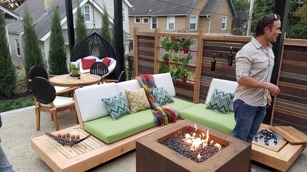 Design ideas for a small modern backyard patio in Kansas City with a fire feature, decomposed granite and a pergola.