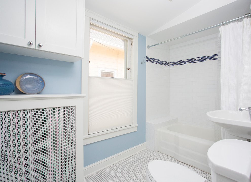 Design ideas for a mid-sized contemporary 3/4 bathroom in Minneapolis with an alcove tub, a shower/bathtub combo, a two-piece toilet, white tile, subway tile, blue walls, ceramic floors, a pedestal sink, shaker cabinets and white cabinets.