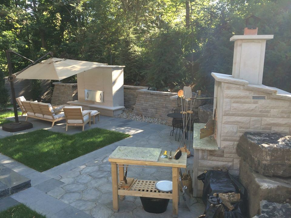 Photo of a contemporary backyard patio in Toronto with an outdoor kitchen and stamped concrete.