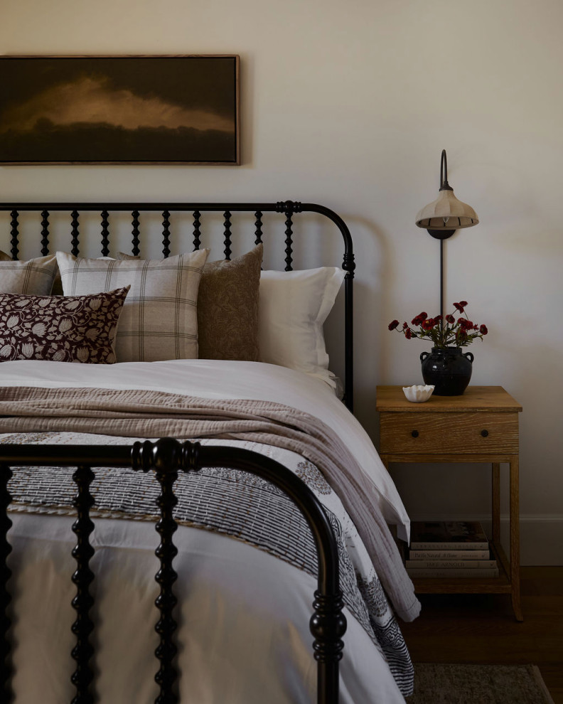 Bedroom - farmhouse medium tone wood floor and brown floor bedroom idea in Oklahoma City with white walls