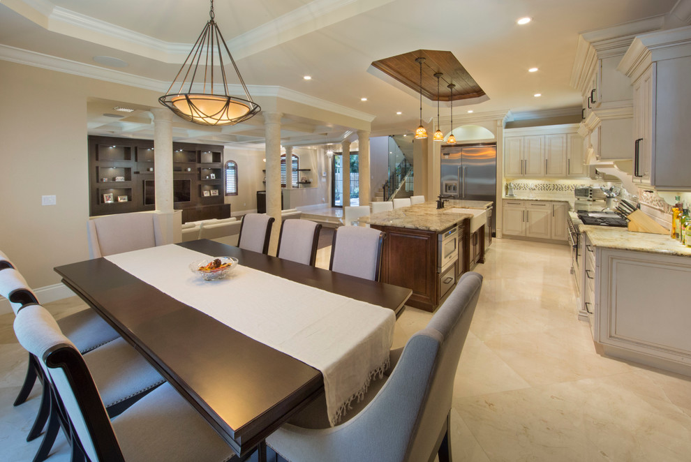 Photo of a large mediterranean l-shaped eat-in kitchen in Miami with with island.