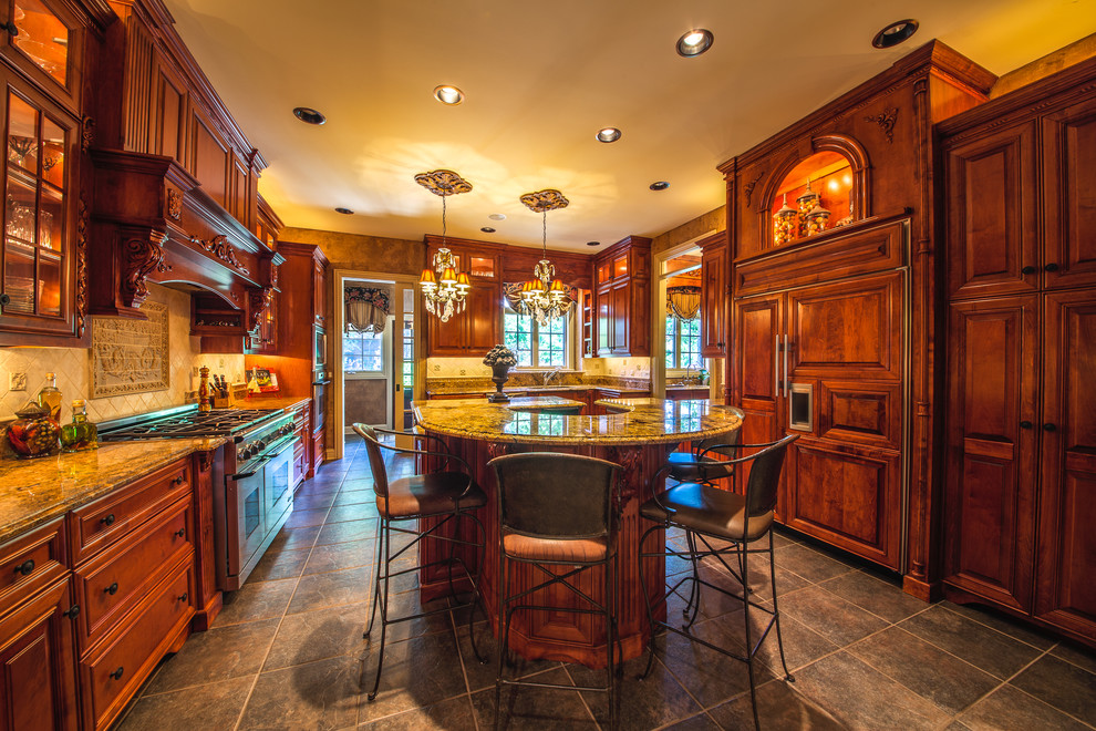 Photo of a traditional u-shaped kitchen in Chicago with recessed-panel cabinets, medium wood cabinets, granite benchtops, beige splashback, ceramic splashback, travertine floors and multiple islands.