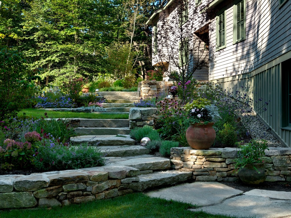 Design ideas for a beach style sloped garden in Portland Maine with natural stone pavers.