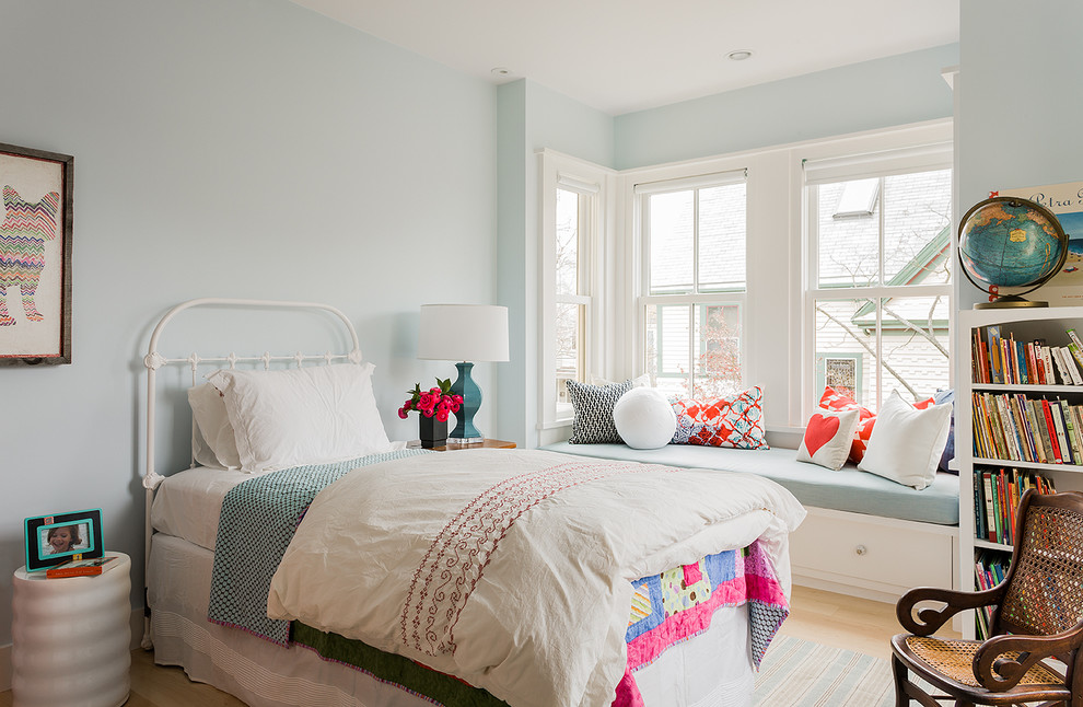 Inspiration for a mid-sized scandinavian kids' bedroom for girls in Boston with blue walls and light hardwood floors.