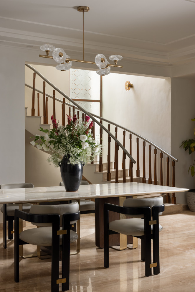 Photo of a contemporary dining room in Bengaluru With White Walls.