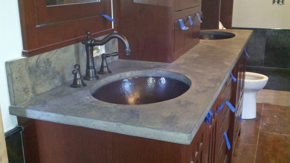 Eclectic master bathroom in Charlotte with an undermount sink and concrete benchtops.