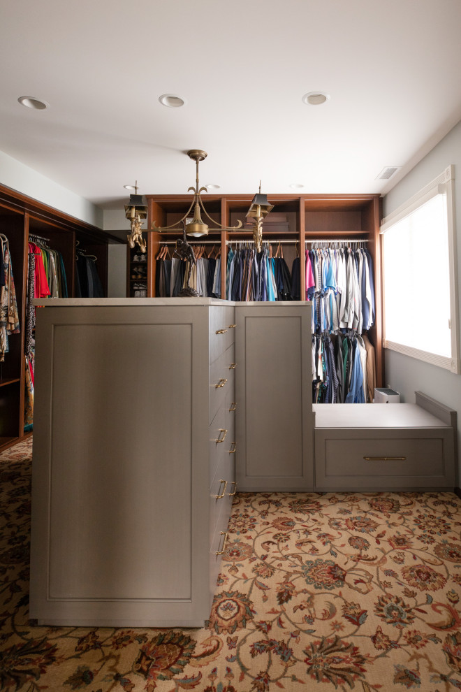 Photo of a large traditional gender-neutral walk-in wardrobe in Milwaukee with flat-panel cabinets, grey cabinets, carpet and multi-coloured floor.