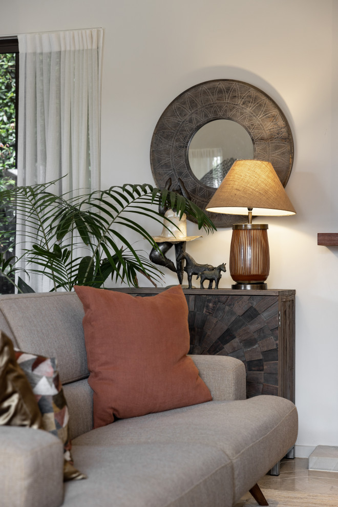 Inspiration for a Large eclectic Open Concept living room in Auckland With White Walls, Porcelain Floors, a Standard Fireplace, a Tile Fireplace Surround, a Wall-mounted TV, Beige Floor and Vaulted.