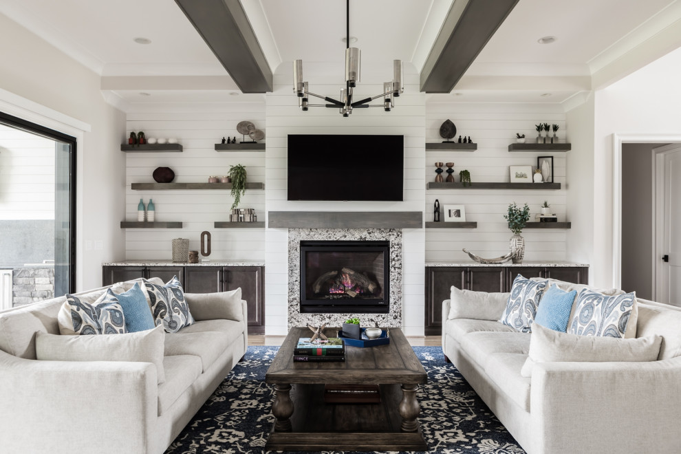 Mid-sized trendy open concept light wood floor and exposed beam living room photo in Raleigh with a standard fireplace, a stone fireplace and a wall-mounted tv