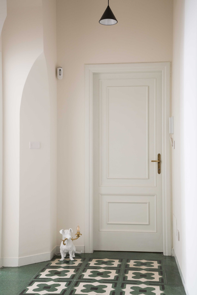 Aménagement d'une porte d'entrée contemporaine avec un mur blanc, un sol en carrelage de céramique, une porte simple, une porte blanche et un sol multicolore.