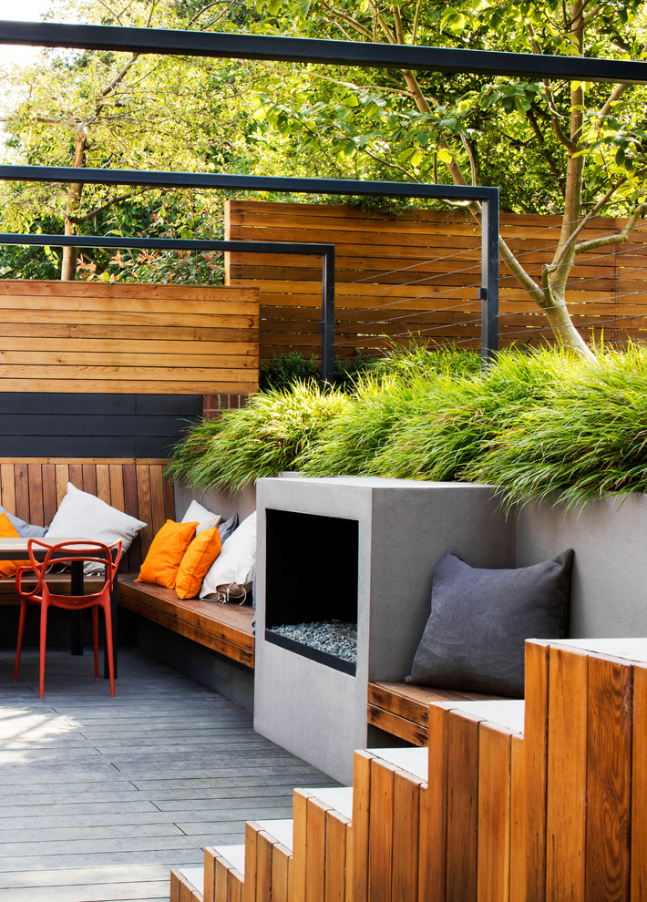 Contemporary deck in London with a fire feature.