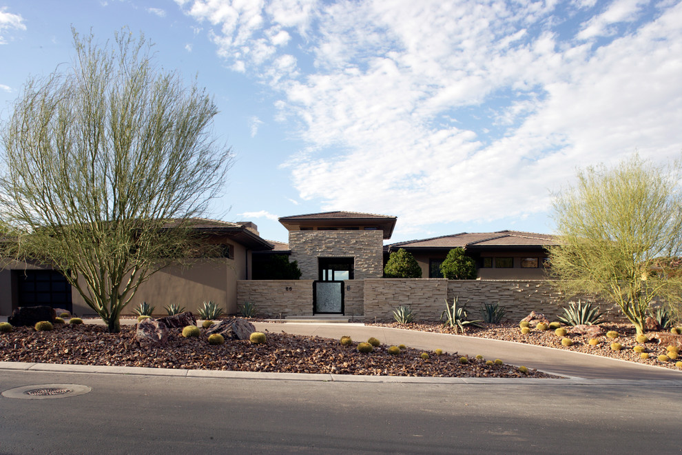 Photo of a contemporary beige exterior in Las Vegas with stone veneer and a hip roof.
