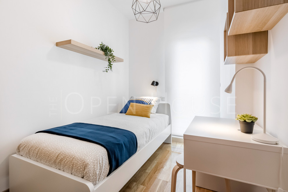 Esempio di una piccola camera da letto design con pareti bianche e pavimento marrone