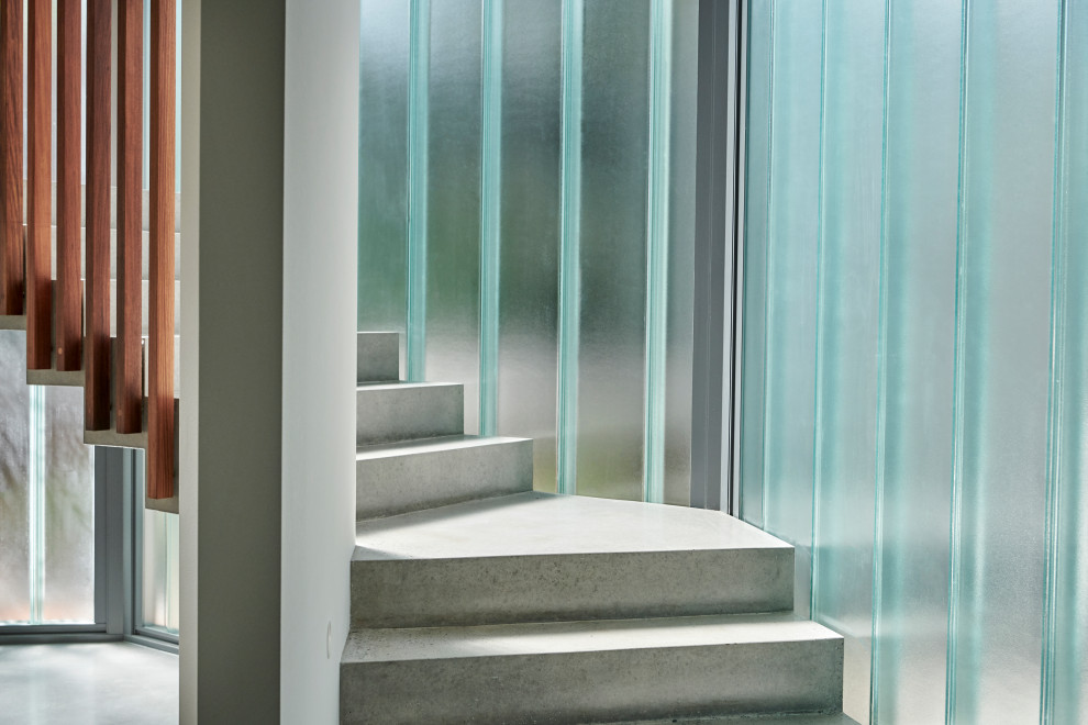 Mid-sized contemporary concrete floating staircase in Perth with concrete risers and wood railing.