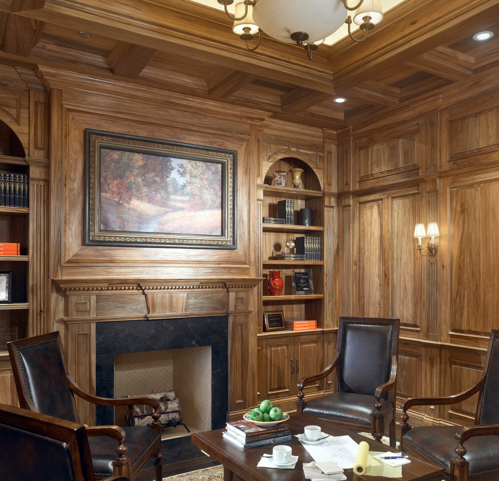 Photo of a small traditional study room in Chicago with medium hardwood floors, a standard fireplace and a wood fireplace surround.