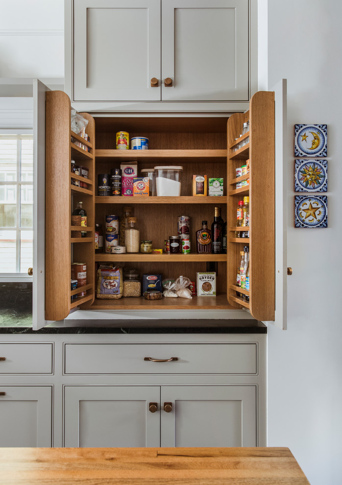 Design ideas for a large traditional u-shaped kitchen pantry in Portland with an undermount sink, beaded inset cabinets, grey cabinets, blue splashback, panelled appliances, with island, grey floor and black benchtop.