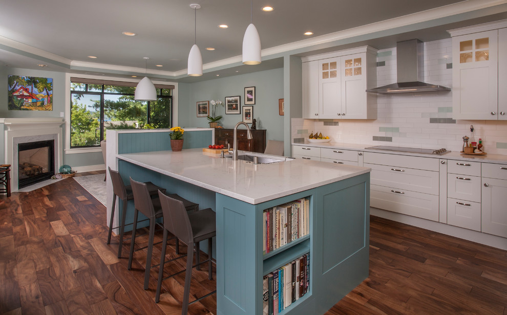Photo of a transitional eat-in kitchen in Seattle with an undermount sink, shaker cabinets, white cabinets, multi-coloured splashback, dark hardwood floors, with island, brown floor and white benchtop.