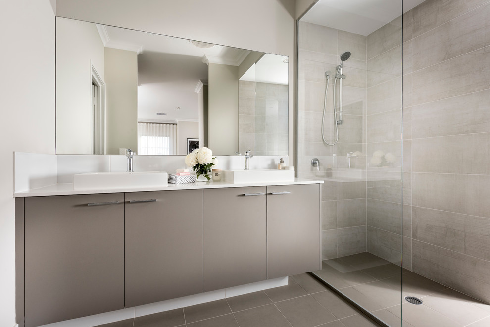 This is an example of a contemporary bathroom in Perth with flat-panel cabinets, grey cabinets, a curbless shower, beige tile, gray tile, white walls, a vessel sink and an open shower.