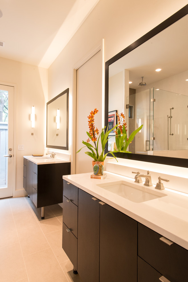 Inspiration for a mid-sized contemporary master bathroom in Dallas with an undermount sink, flat-panel cabinets, dark wood cabinets, engineered quartz benchtops, a freestanding tub, a corner shower, gray tile, porcelain tile, white walls and porcelain floors.