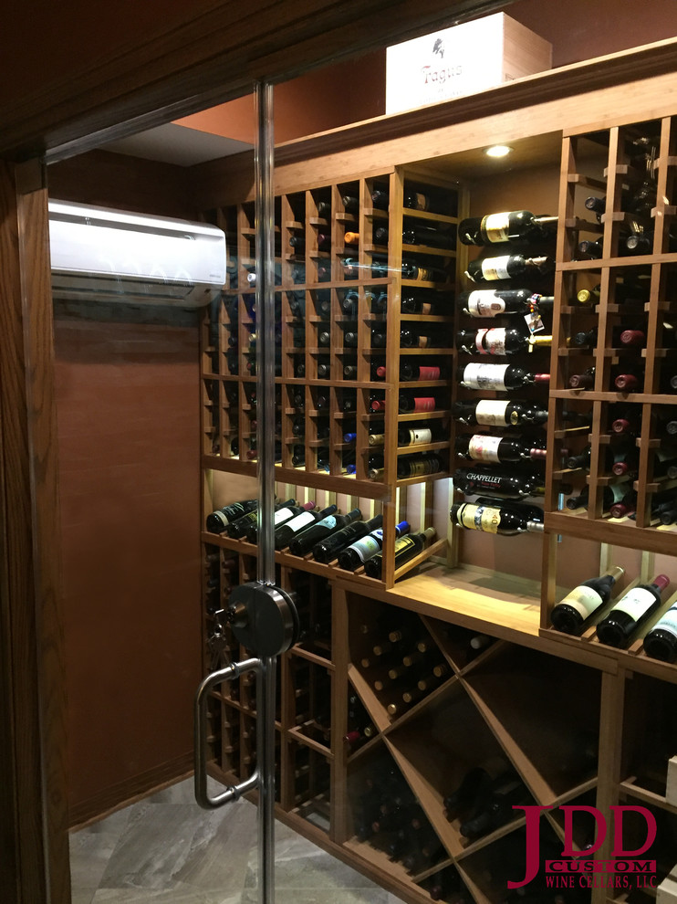 Inspiration for a mid-sized traditional wine cellar in Cincinnati with porcelain floors and storage racks.