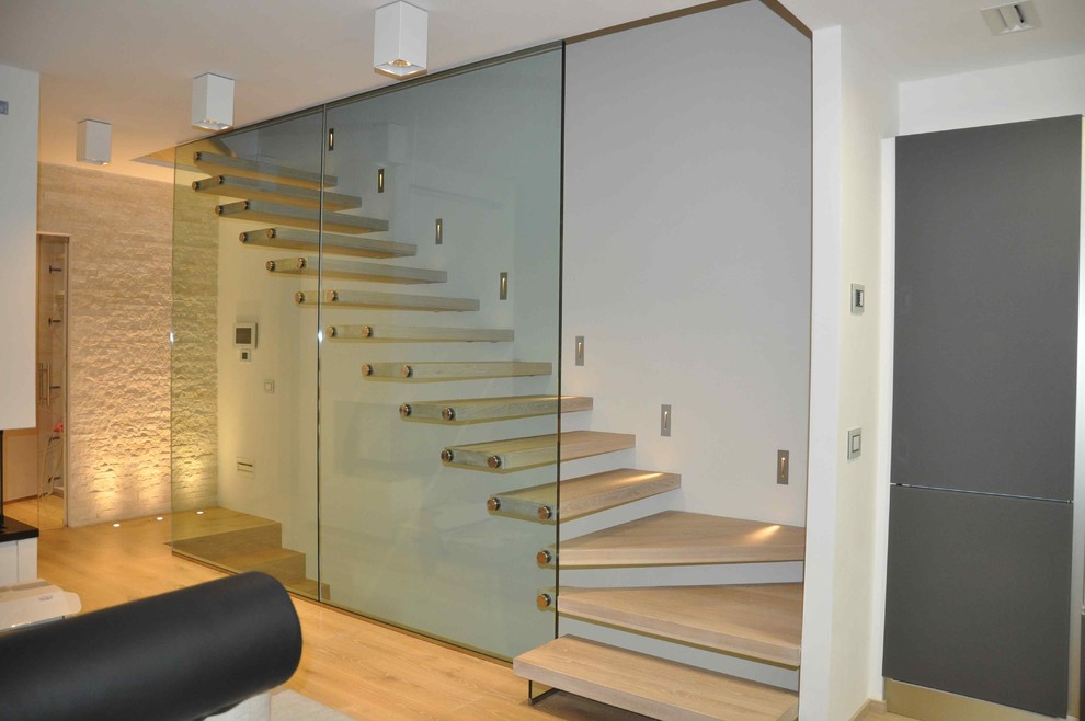 Large modern painted wood l-shaped staircase in Milan with open risers.