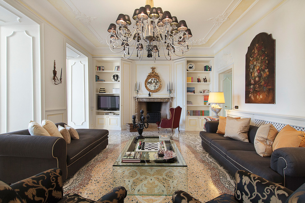 Inspiration for a traditional formal living room in Milan with white walls and a standard fireplace.