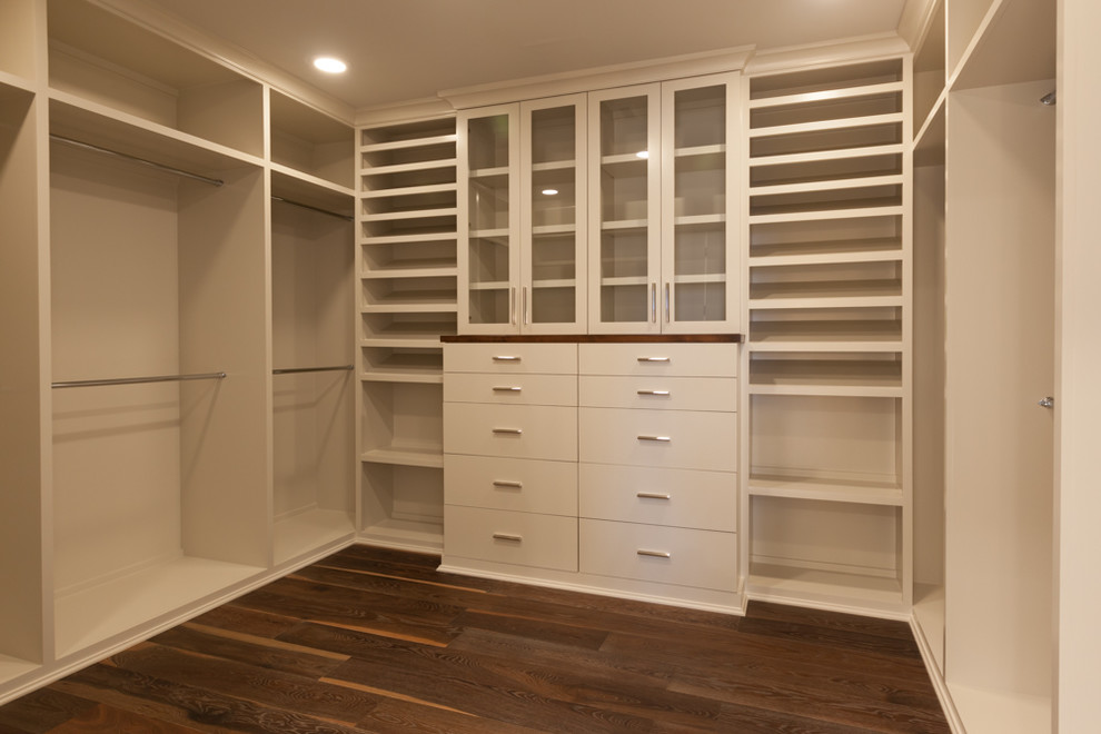 Photo of a large transitional gender-neutral walk-in wardrobe in Houston with flat-panel cabinets, white cabinets and dark hardwood floors.