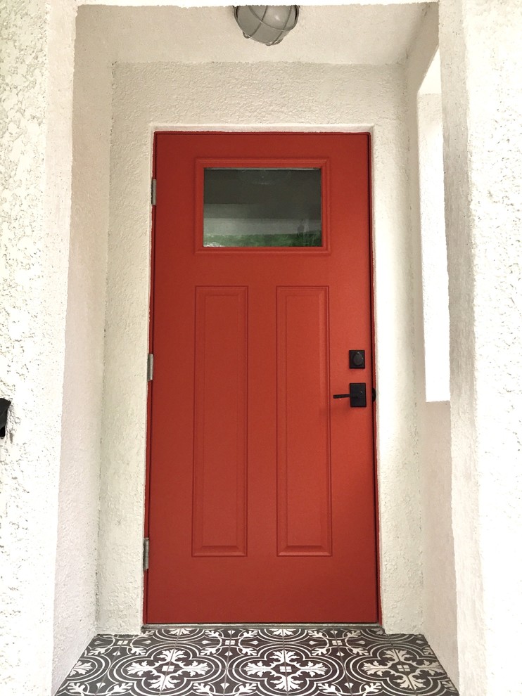 Mid-sized traditional entryway in Tampa with white walls, a single front door and an orange front door.