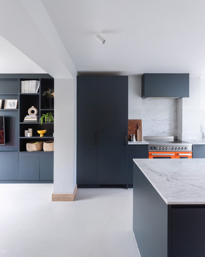 This is an example of a medium sized contemporary single-wall open plan kitchen in London with an integrated sink, flat-panel cabinets, blue cabinets, marble worktops, white splashback, marble splashback, coloured appliances, an island, beige floors, white worktops and exposed beams.
