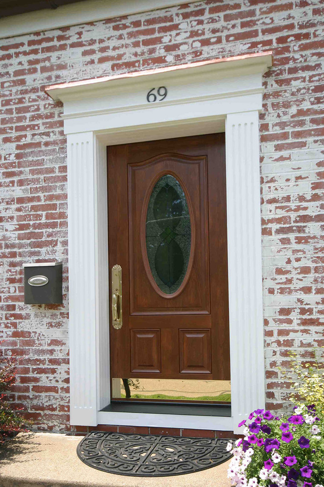 Photo of a mid-sized traditional front door in Denver with a single front door and a medium wood front door.