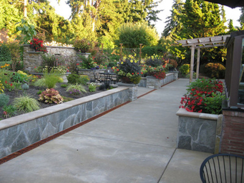 Inspiration for a large traditional backyard patio in Seattle with a water feature, concrete pavers and no cover.