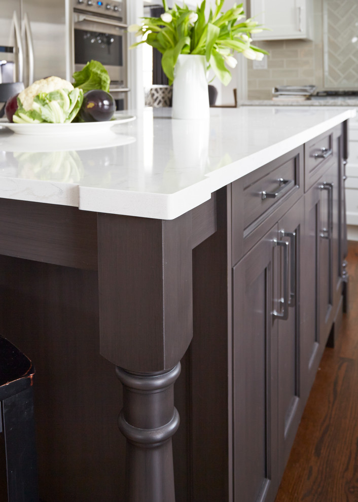 Example of a large transitional u-shaped medium tone wood floor open concept kitchen design in Chicago with a double-bowl sink, flat-panel cabinets, white cabinets, quartz countertops, beige backsplash, subway tile backsplash, stainless steel appliances and an island