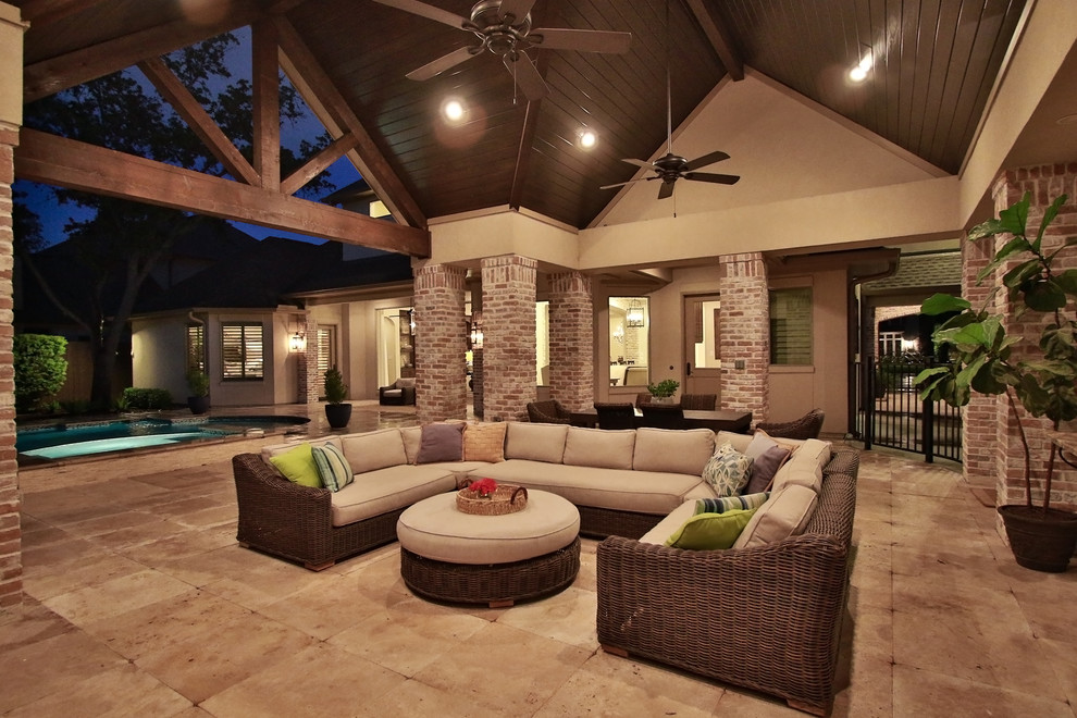 Expansive traditional backyard patio in Houston with an outdoor kitchen, natural stone pavers and a gazebo/cabana.