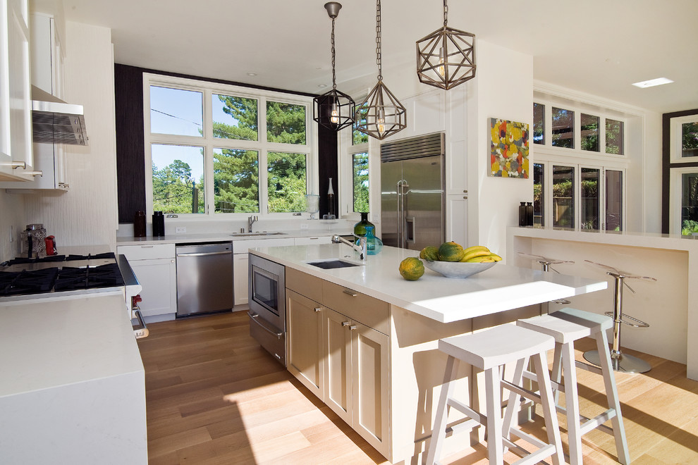 Photo of a contemporary u-shaped kitchen in San Francisco with stainless steel appliances and an undermount sink.