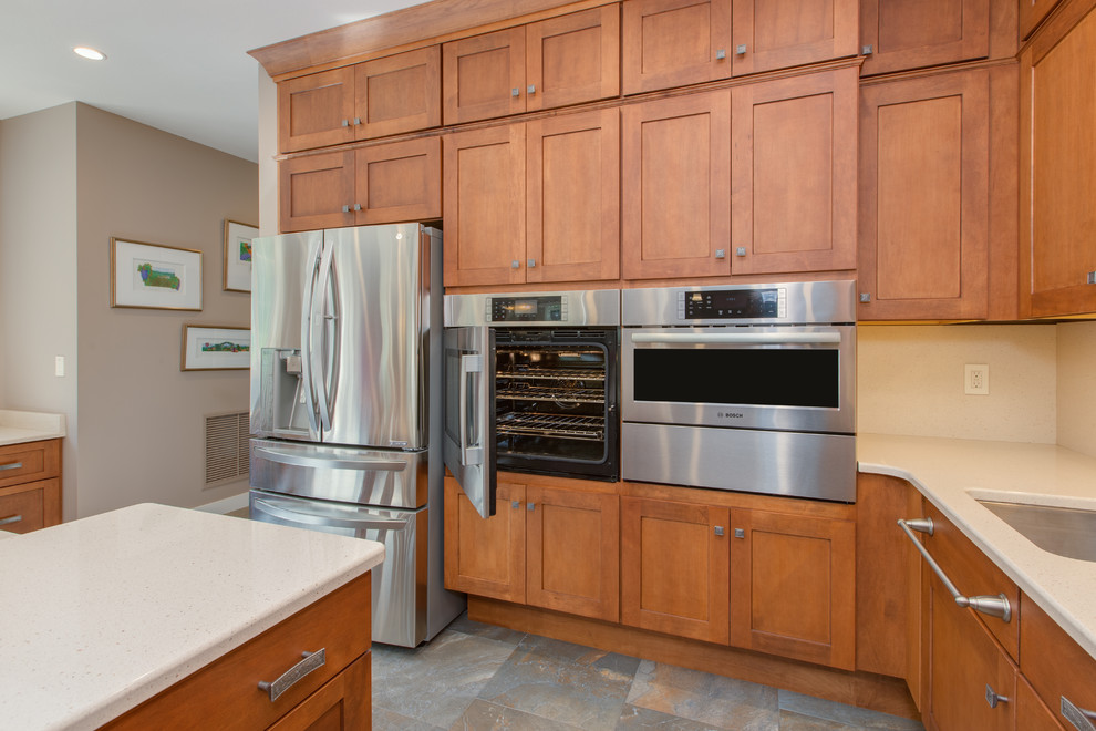 Open concept kitchen - huge transitional u-shaped open concept kitchen idea in Boston with an undermount sink, shaker cabinets, medium tone wood cabinets, quartz countertops, stone slab backsplash, stainless steel appliances and an island