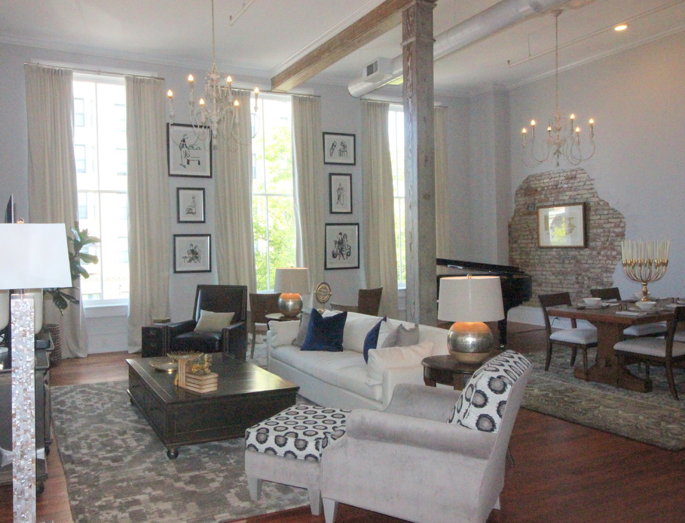 Living room - mid-sized industrial loft-style medium tone wood floor and brown floor living room idea in Atlanta with a music area, gray walls and no fireplace