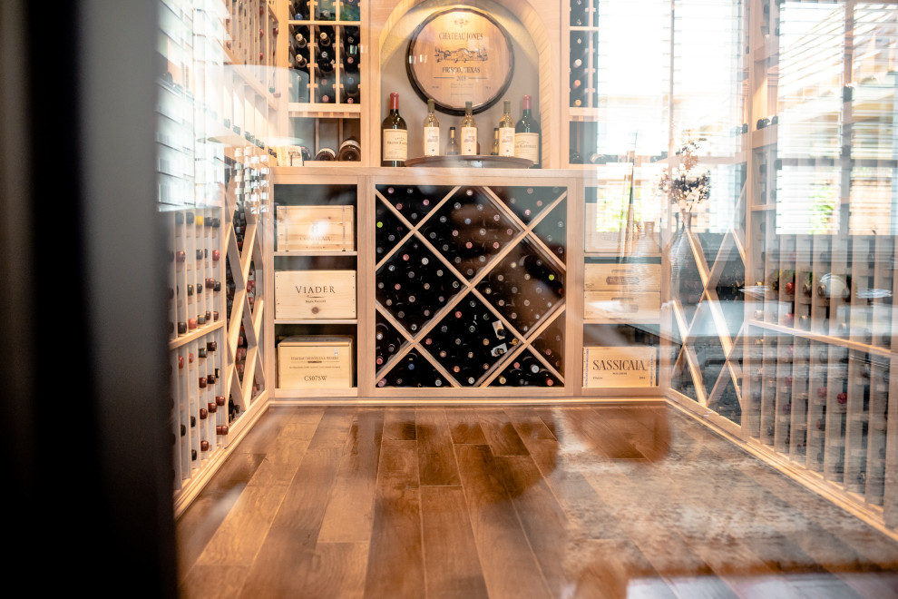 This is an example of a mid-sized wine cellar in Dallas with storage racks and brown floor.