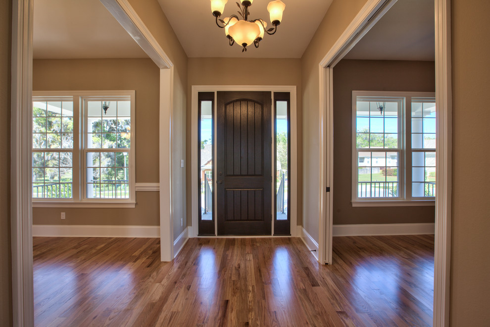 Photo of a mid-sized traditional front door in Atlanta with beige walls, dark hardwood floors, a single front door and a dark wood front door.