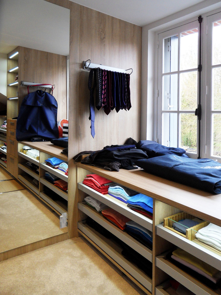 Inspiration for a large contemporary men's dressing room in Other with open cabinets and carpet.
