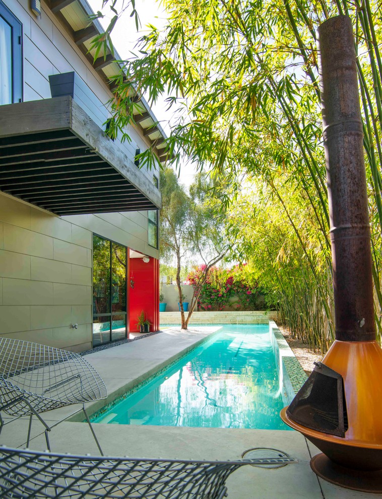 This is an example of a midcentury custom-shaped pool in Phoenix.