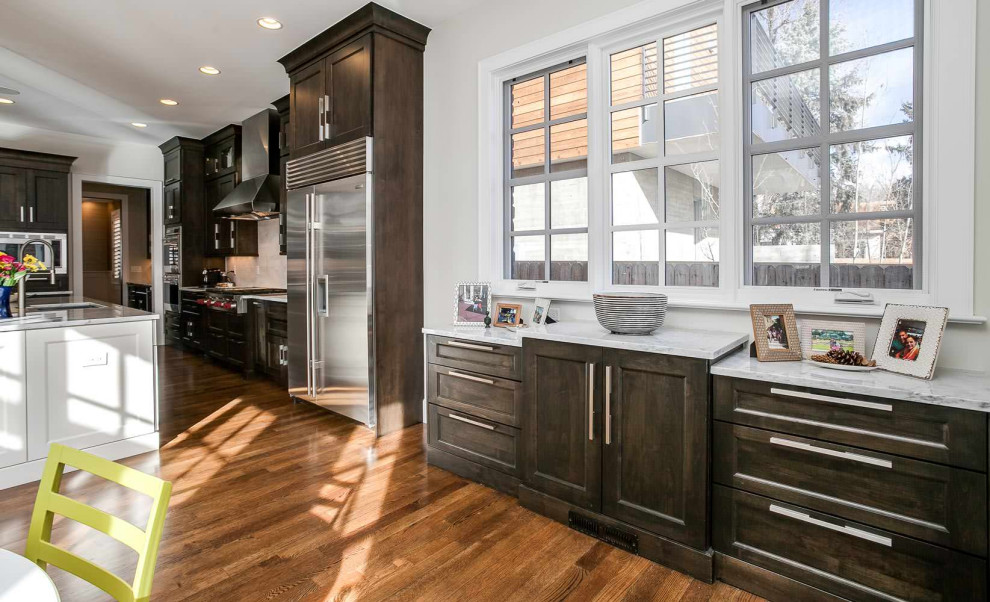 Example of a mid-sized transitional medium tone wood floor eat-in kitchen design in Santa Barbara with an undermount sink and stainless steel appliances