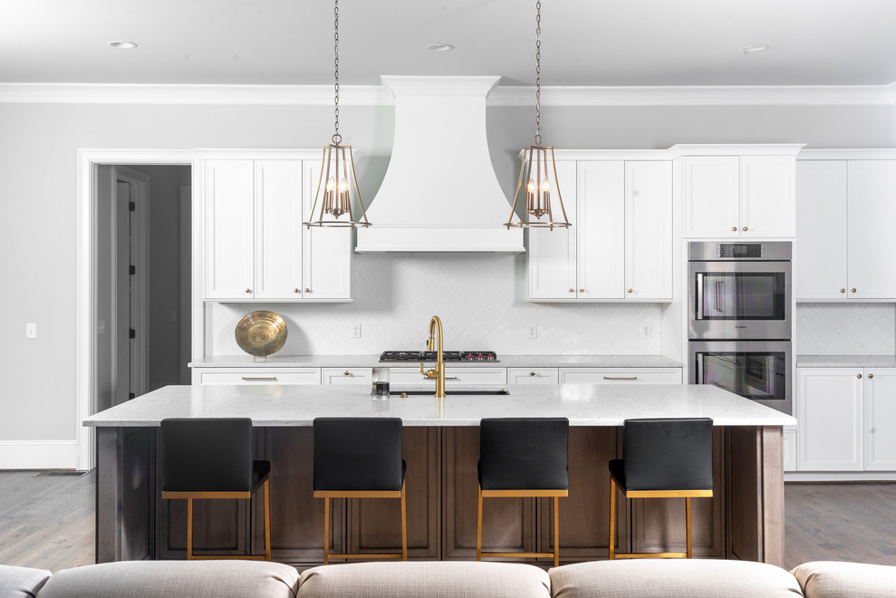 Inspiration for a large transitional galley eat-in kitchen in Other with an undermount sink, quartz benchtops, with island, white benchtop, recessed-panel cabinets, white cabinets, grey splashback, stainless steel appliances, dark hardwood floors and brown floor.