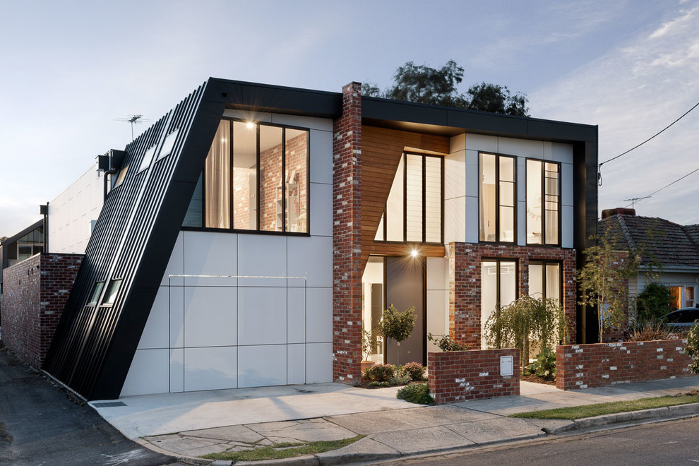 Design ideas for a mid-sized contemporary two-storey multi-coloured house exterior in Melbourne with a flat roof, a metal roof and mixed siding.