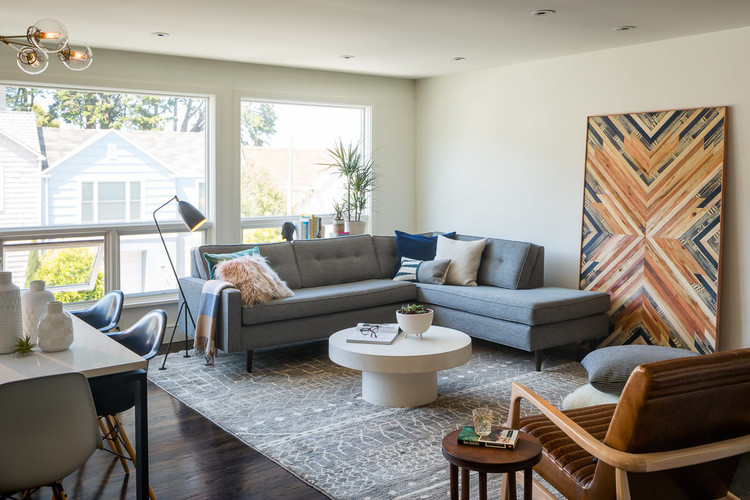 This is an example of a mid-sized midcentury open concept living room in San Francisco with white walls, dark hardwood floors and a wall-mounted tv.