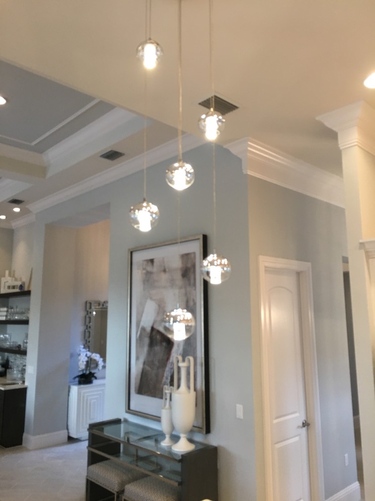 Inspiration for a transitional kitchen remodel in Miami with a double-bowl sink, raised-panel cabinets, white cabinets, granite countertops, white backsplash and stainless steel appliances