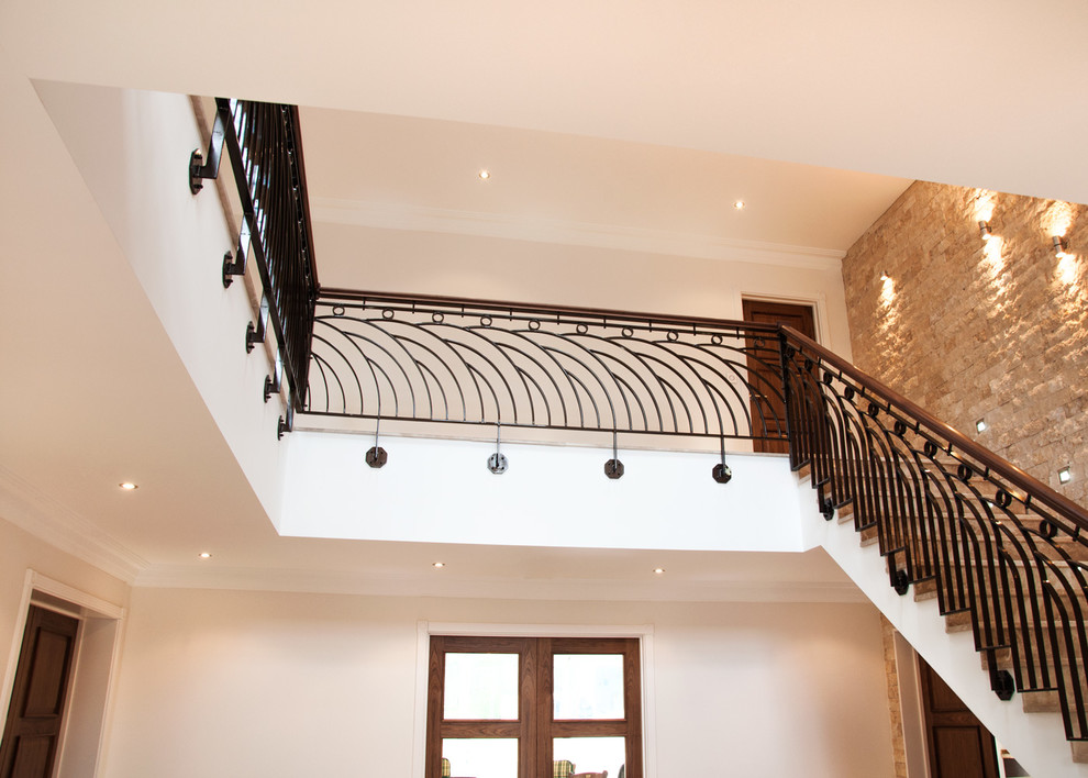 This is an example of a large transitional marble straight staircase in Buckinghamshire with marble risers and mixed railing.