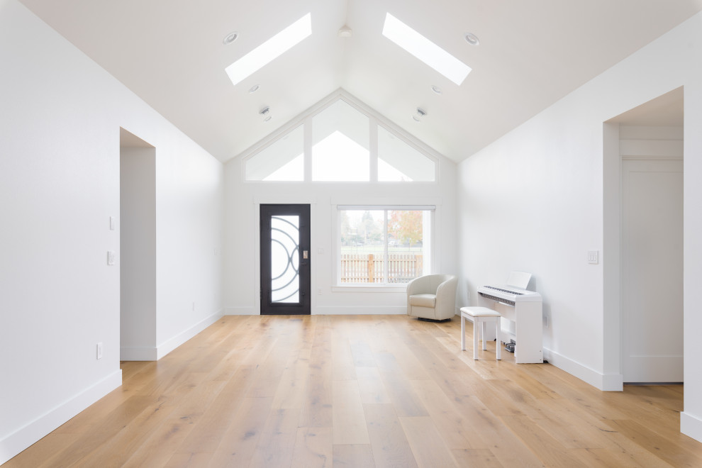 Design ideas for an expansive scandinavian entryway in Seattle with white walls, light hardwood floors and beige floor.